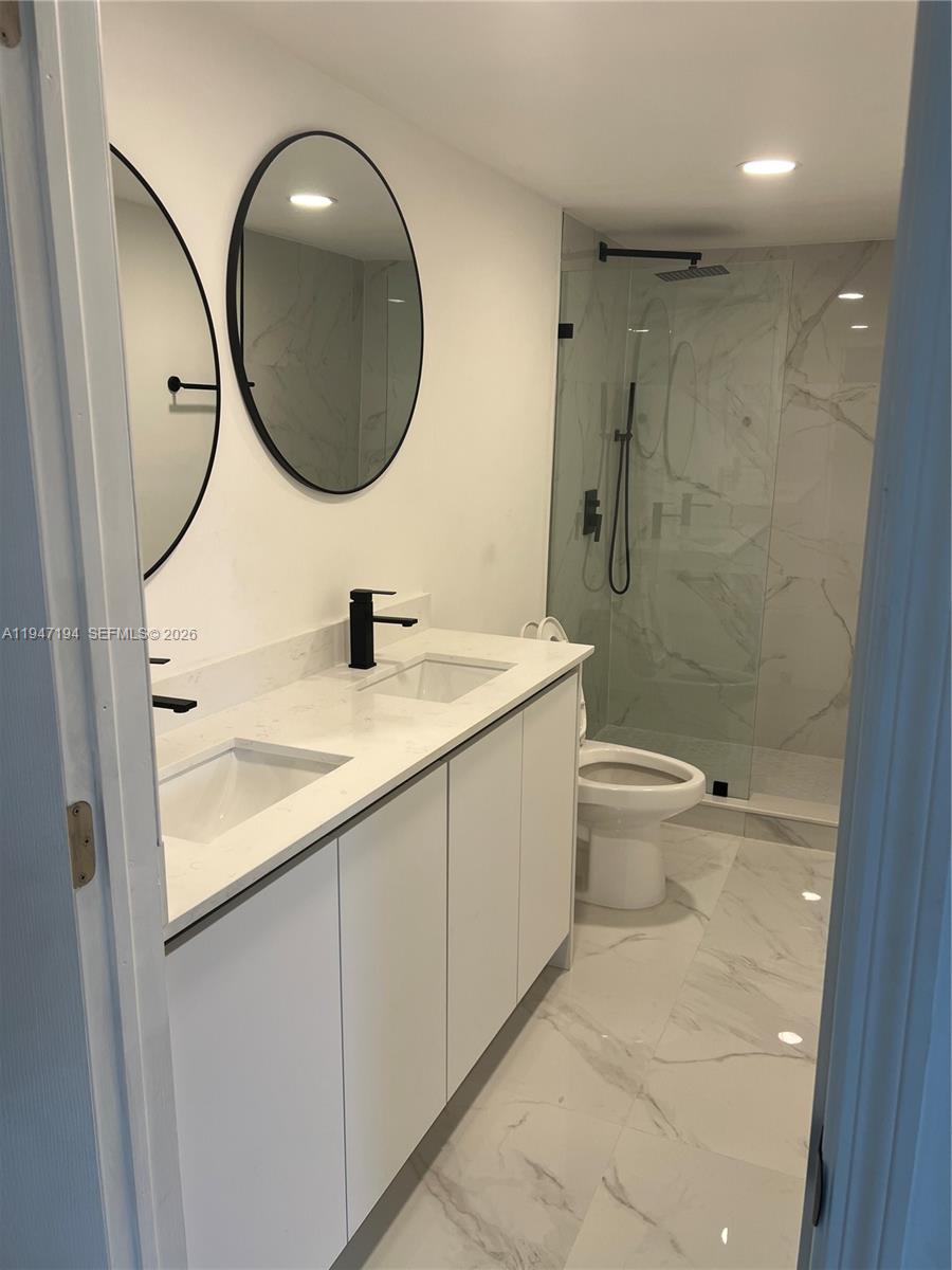 6104 Southwest 33rd Street Miramar, FL 33023 - Photo 31 of 31 a bathroom with a sink a toilet and a mirror