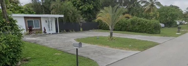 a backyard of a house with plants and trees