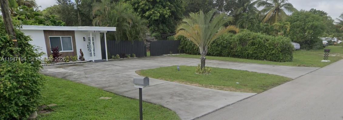 6104 Southwest 33rd Street Miramar, FL 33023 - Photo 4 of 31 a backyard of a house with plants and trees