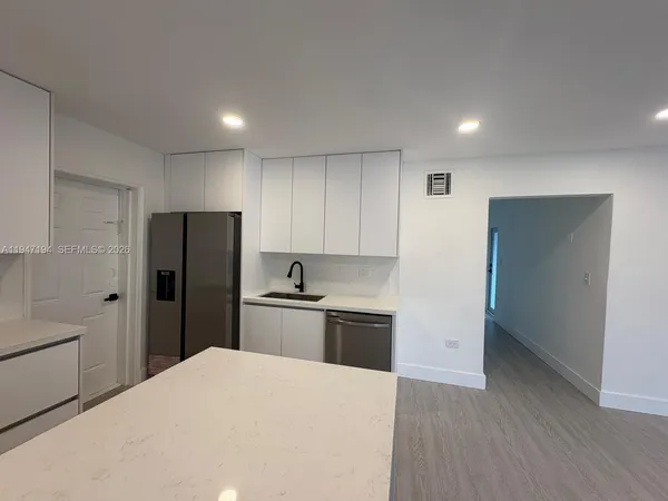 a kitchen with a refrigerator a sink and dishwasher