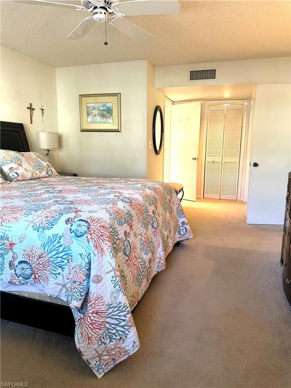 214 Bobolink Way, Unit 214B Naples, FL 34105 - Photo 11 of 15 Carpeted bedroom featuring ceiling fan and a textured ceiling