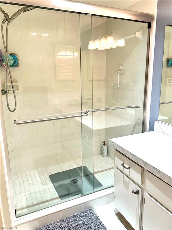 214 Bobolink Way, Unit 214B Naples, FL 34105 - Photo 13 of 15 Bathroom with vanity and an enclosed shower