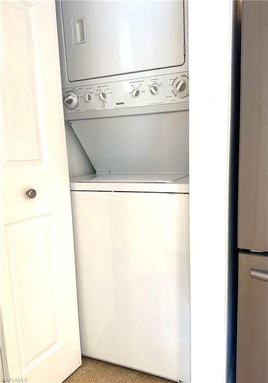214 Bobolink Way, Unit 214B Naples, FL 34105 - Photo 15 of 15 Washroom with stacked washer / dryer