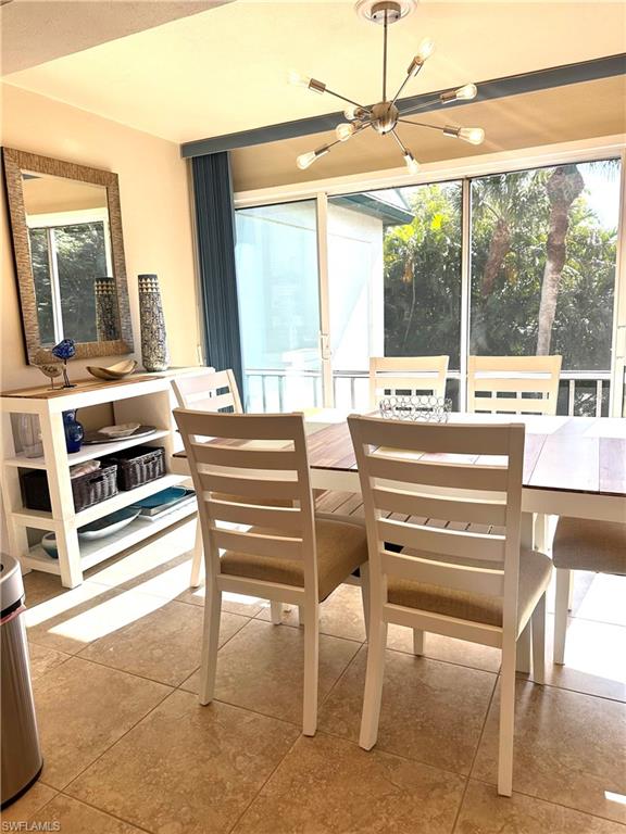 214 Bobolink Way, Unit 214B Naples, FL 34105 - Photo 4 of 15 Sunroom featuring a chandelier