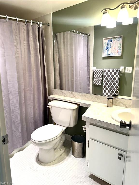 214 Bobolink Way, Unit 214B Naples, FL 34105 - Photo 9 of 15 Bathroom featuring tile patterned flooring, vanity, walk in shower, and toilet