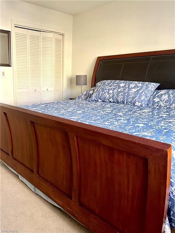 214 Bobolink Way, Unit 214B Naples, FL 34105 - Photo 10 of 15 Carpeted bedroom with a closet