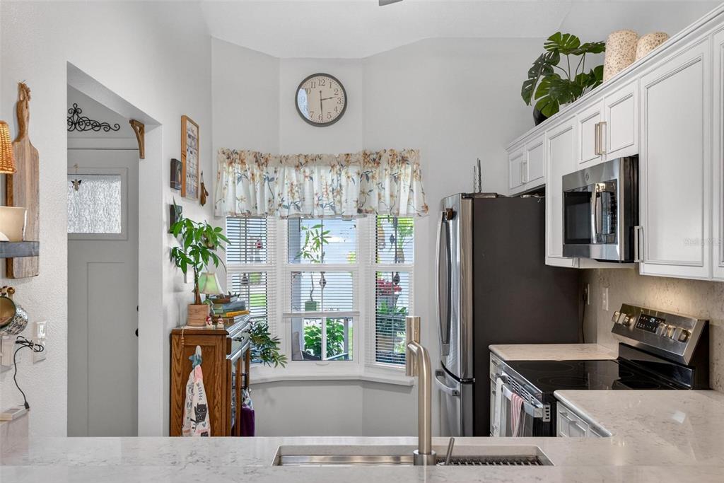 6506 Thicket Trail New Port Richey, FL 34653 - Photo 12 of 71 a kitchen with stainless steel appliances granite countertop a refrigerator and a stove top oven