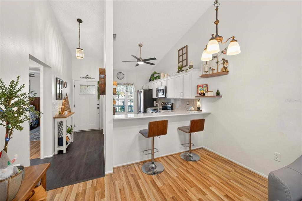 6506 Thicket Trail New Port Richey, FL 34653 - Photo 23 of 71 a view of kitchen and dining room with wooden floor
