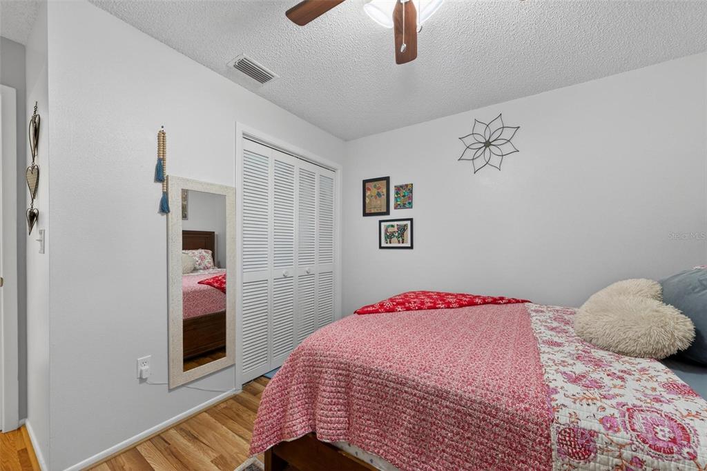 6506 Thicket Trail New Port Richey, FL 34653 - Photo 35 of 71 a bedroom with a bed and a dresser