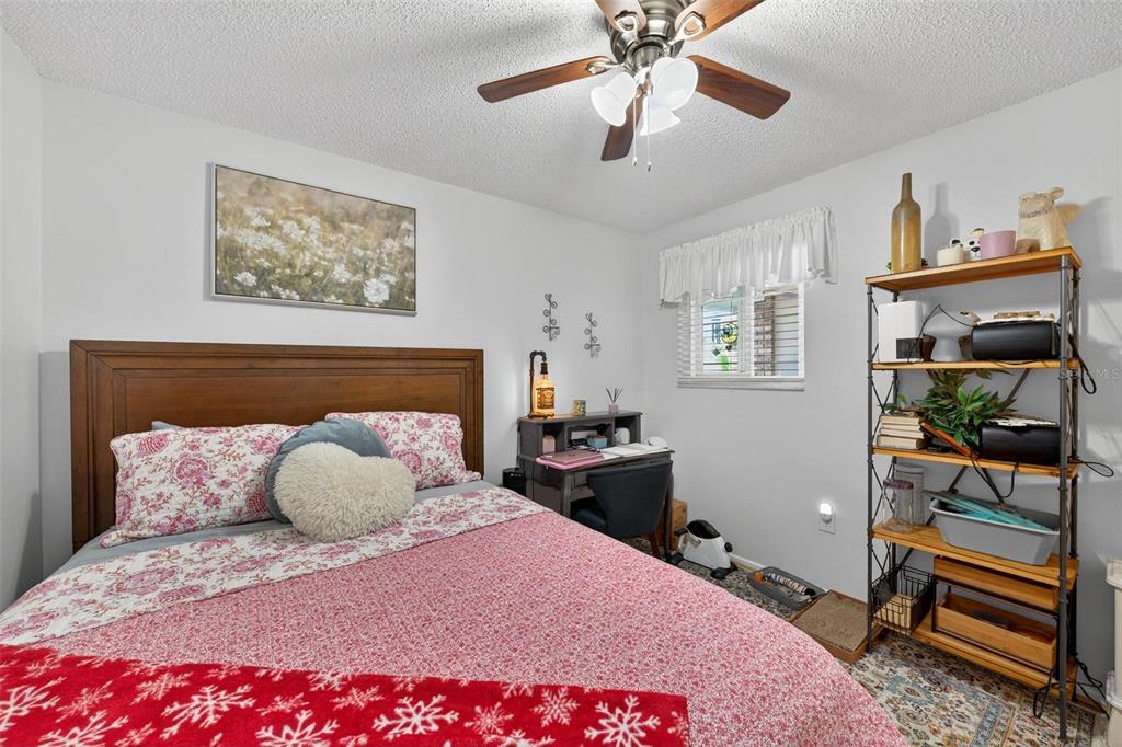 6506 Thicket Trail New Port Richey, FL 34653 - Photo 36 of 71 a bedroom with a bed and a chandelier