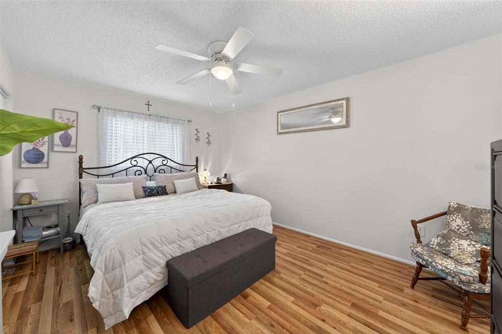 6506 Thicket Trail New Port Richey, FL 34653 - Photo 40 of 71 a bedroom with a bed and wooden floor