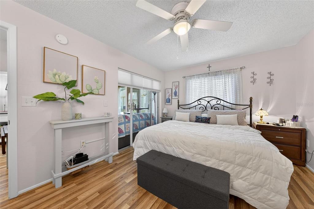 6506 Thicket Trail New Port Richey, FL 34653 - Photo 41 of 71 a bedroom with a bed and a chandelier