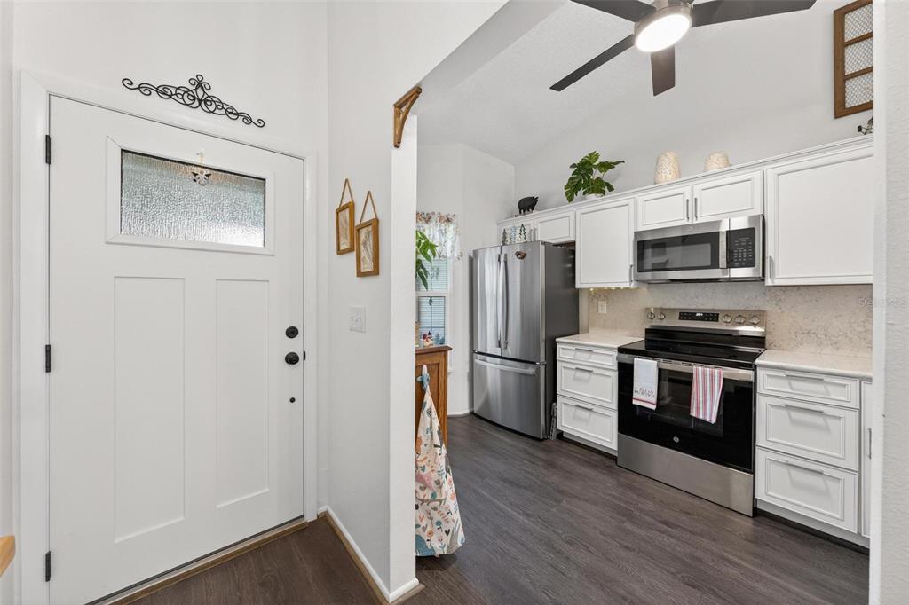 6506 Thicket Trail New Port Richey, FL 34653 - Photo 9 of 71 a kitchen with stainless steel appliances a refrigerator stove and microwave