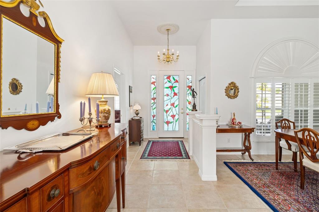 1016 Scherer Way Osprey, FL 34229 - Photo 18 of 76 a very nice looking dining room with a table chairs and a kitchen view