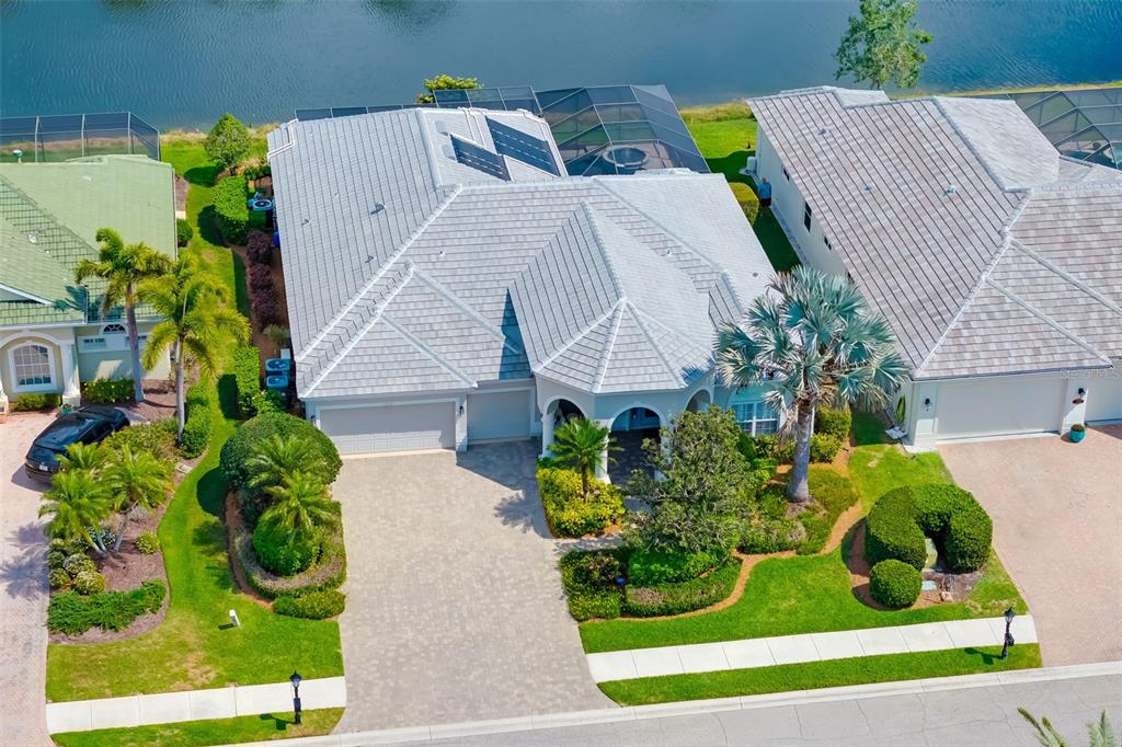 1016 Scherer Way Osprey, FL 34229 - Photo 2 of 76 a aerial view of a house with a yard and potted plants