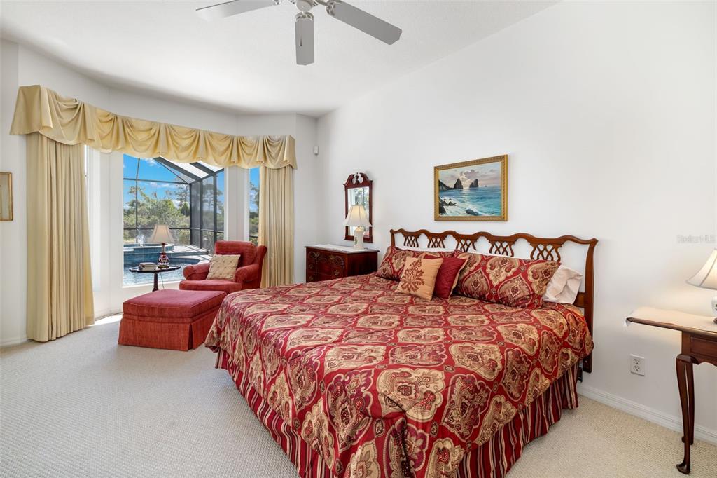 1016 Scherer Way Osprey, FL 34229 - Photo 23 of 76 a bedroom with bed and glass windows