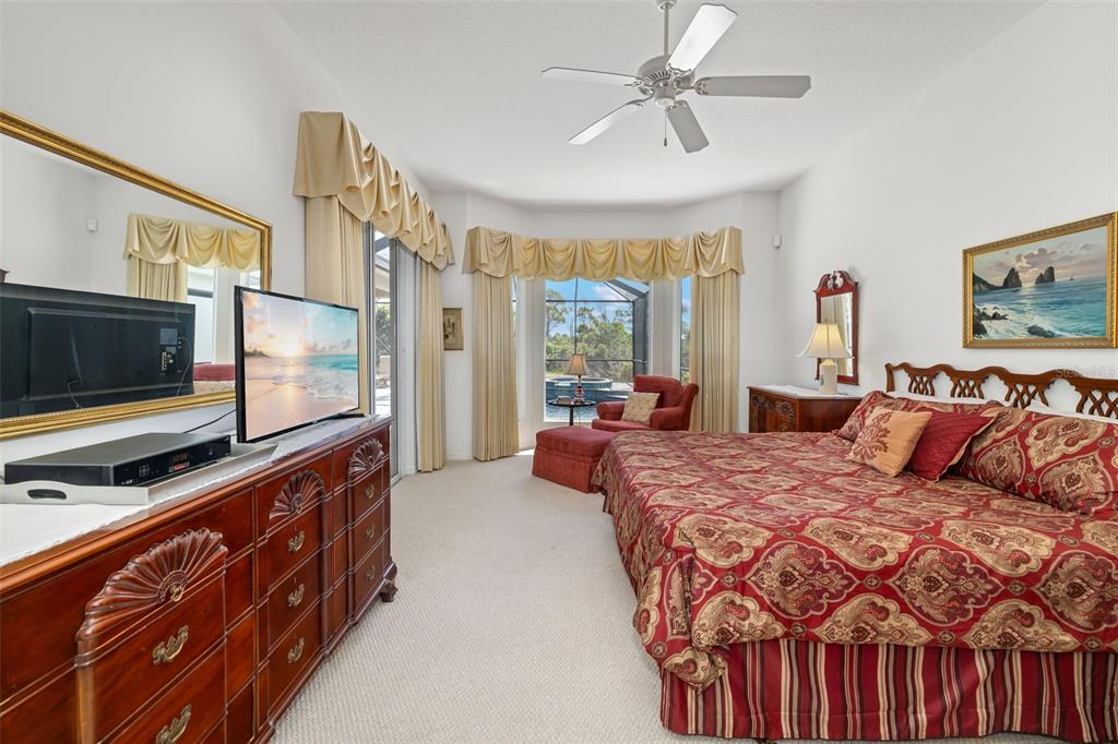 1016 Scherer Way Osprey, FL 34229 - Photo 25 of 76 a bedroom with a bed and a flat tv screen on dresser