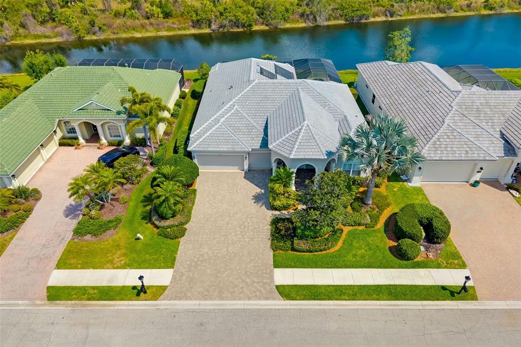 1016 Scherer Way Osprey, FL 34229 - Photo 3 of 76 an aerial view of a house with a yard and lake view