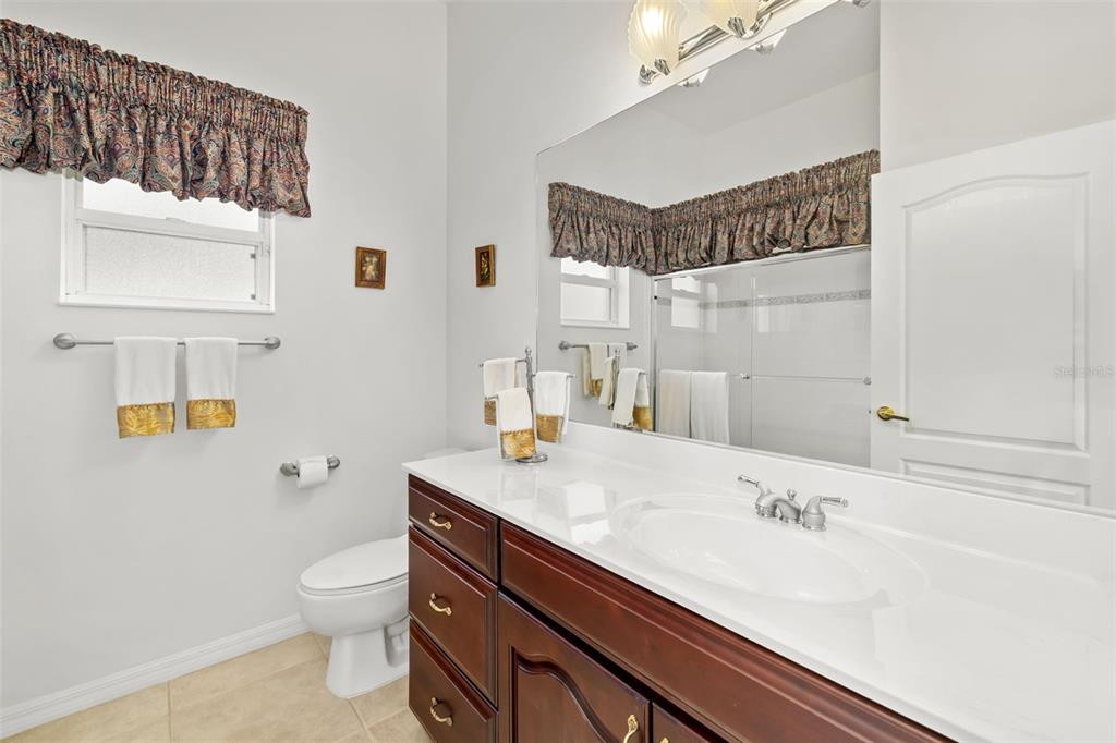 1016 Scherer Way Osprey, FL 34229 - Photo 34 of 76 a bathroom with a sink a toilet and a mirror