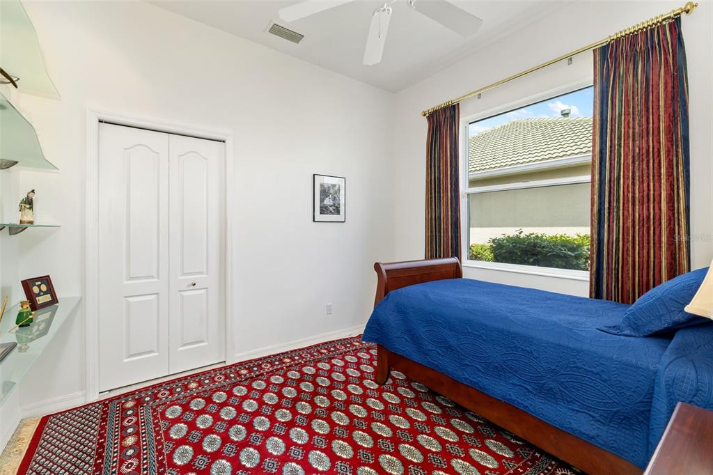 1016 Scherer Way Osprey, FL 34229 - Photo 39 of 76 a bedroom with a bed and a window