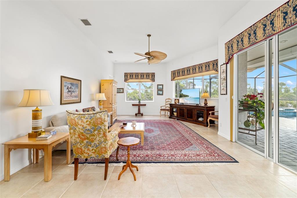 1016 Scherer Way Osprey, FL 34229 - Photo 41 of 76 a living room with furniture a rug and a chandelier