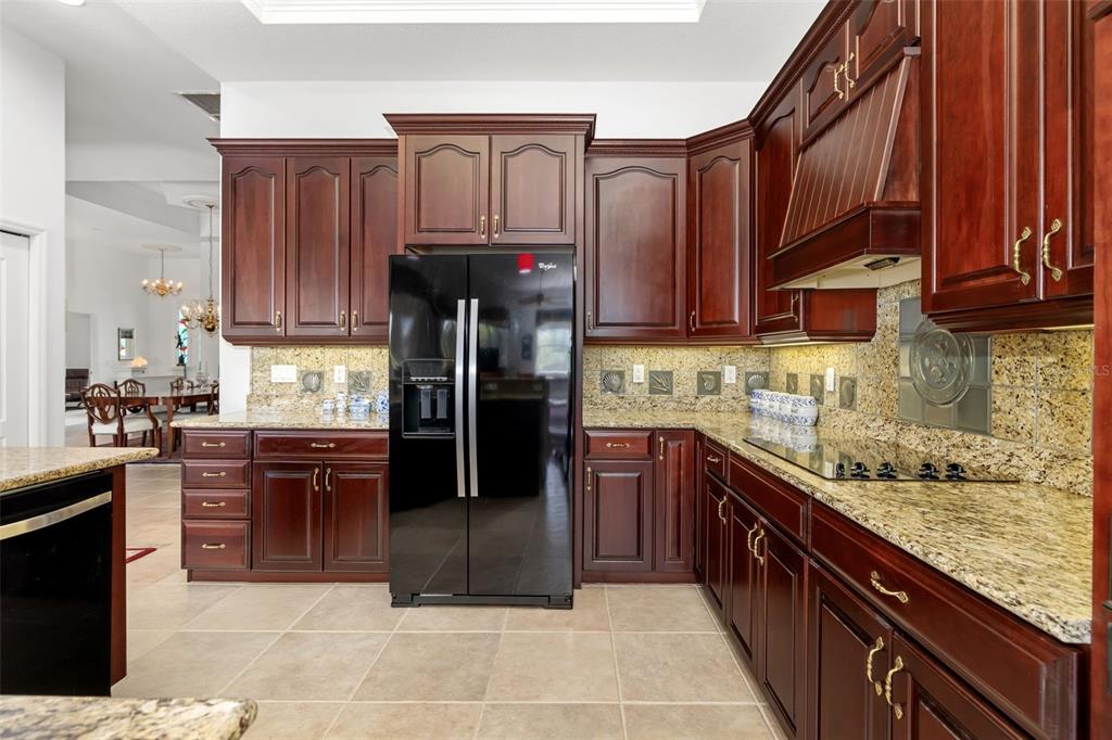 1016 Scherer Way Osprey, FL 34229 - Photo 50 of 76 a kitchen with stainless steel appliances granite countertop a stove refrigerator and cabinets