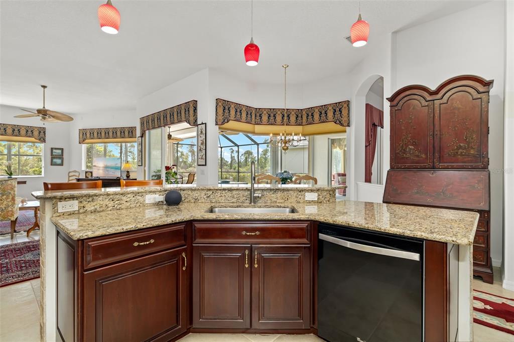 1016 Scherer Way Osprey, FL 34229 - Photo 51 of 76 a kitchen with granite countertop a stove and a sink