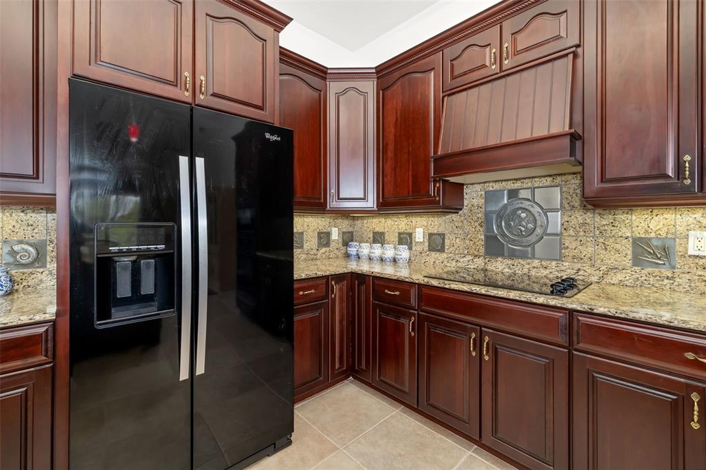 1016 Scherer Way Osprey, FL 34229 - Photo 52 of 76 a kitchen with stainless steel appliances granite countertop a refrigerator and a sink