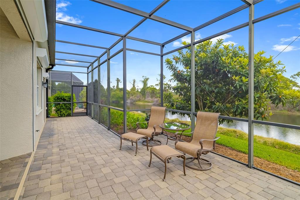 1016 Scherer Way Osprey, FL 34229 - Photo 58 of 76 a view of a patio with a table chairs and a yard
