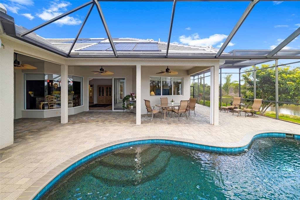 1016 Scherer Way Osprey, FL 34229 - Photo 61 of 76 a view of a swimming pool with a dining table and chairs