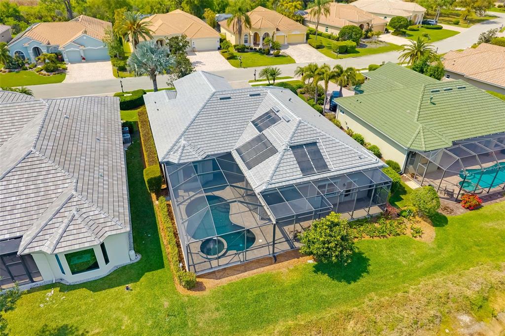 1016 Scherer Way Osprey, FL 34229 - Photo 8 of 76 an aerial view of a house with swimming pool and large trees
