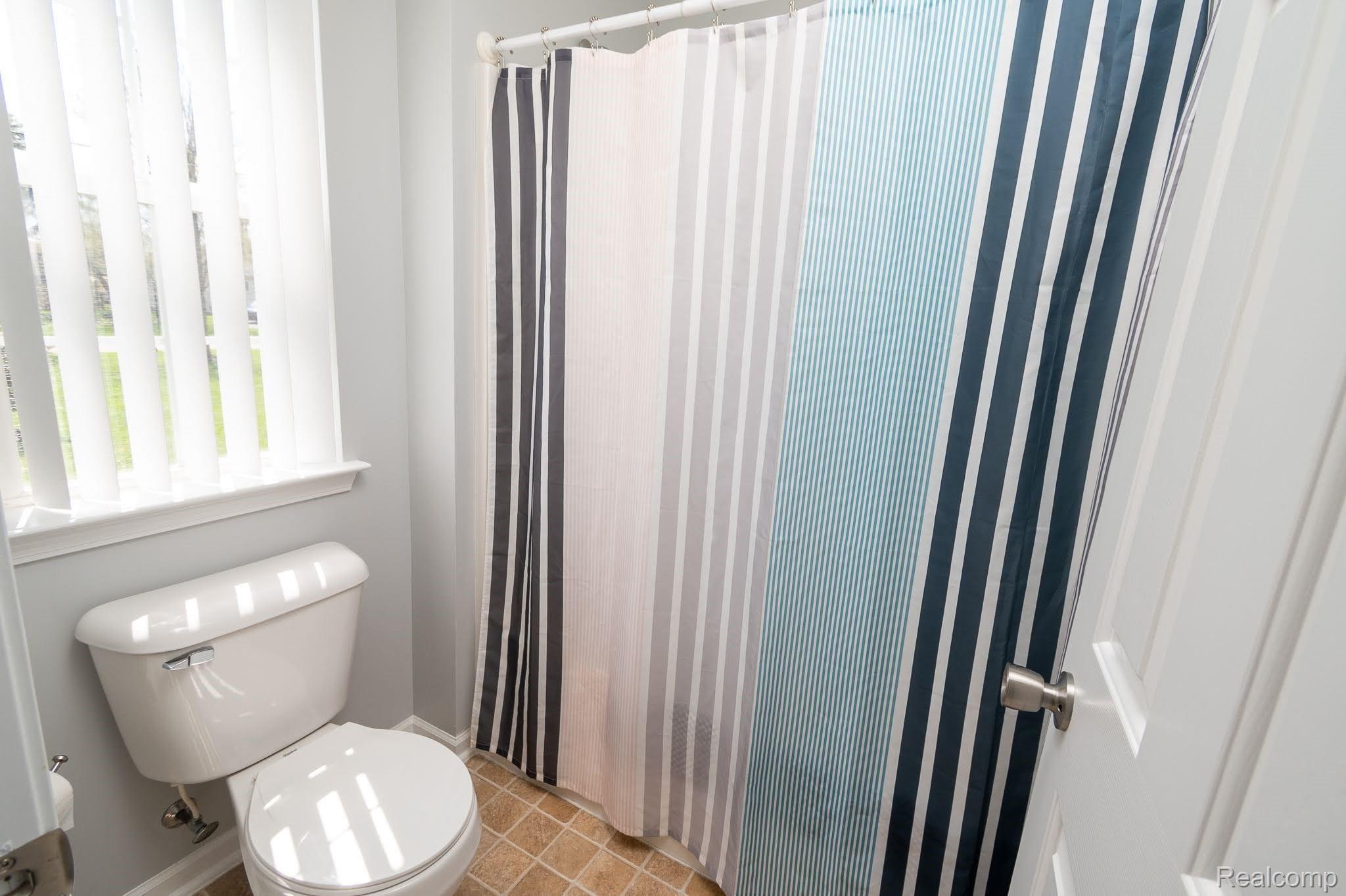 2457 Durham Road Utica, MI 48317 - Photo 15 of 27 toilet and shower area in double entrance bathroom
