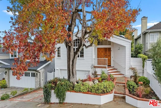 front view of a house with potted plants