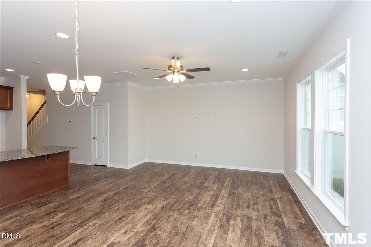 6507 Academic Avenue Raleigh, NC 27616 - Photo 5 of 11 a view of a room with wooden floor and a ceiling fan