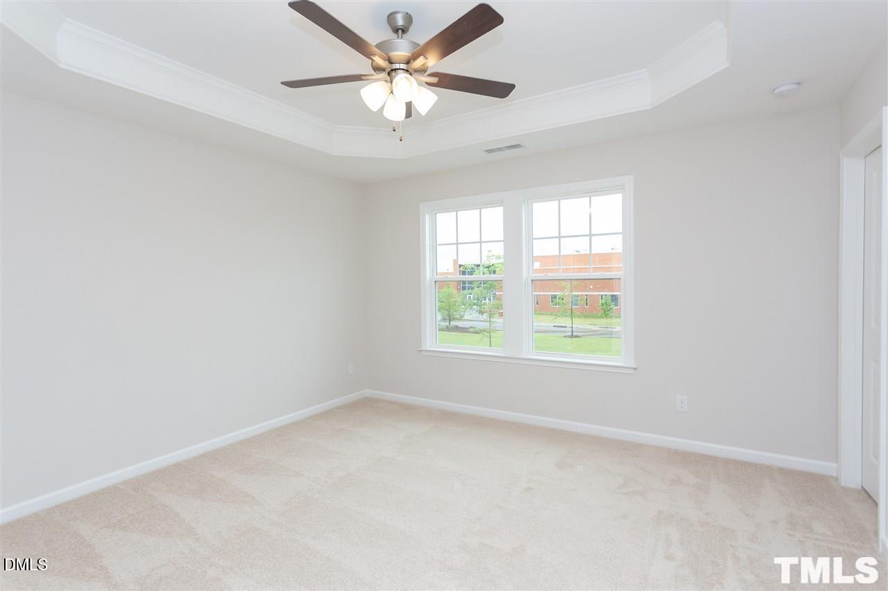 6507 Academic Avenue Raleigh, NC 27616 - Photo 7 of 11 an empty room with a window and a fan