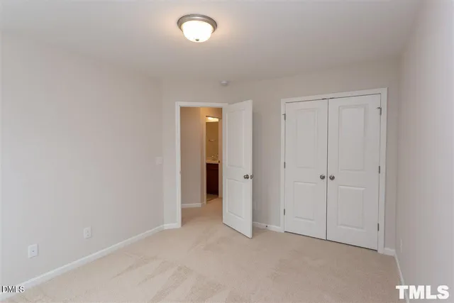 an empty room with closet area