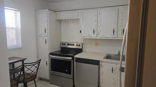 a view of a storage and utility room with washer and dryer
