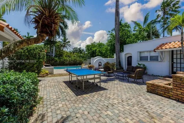 a view of a backyard with furniture and a patio