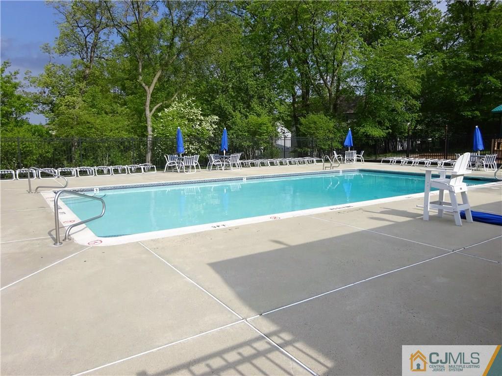 601 Porter Way West Bridgewater, NJ 08807 - Photo 14 of 15 a view of a swimming pool with a lawn chairs under an umbrella