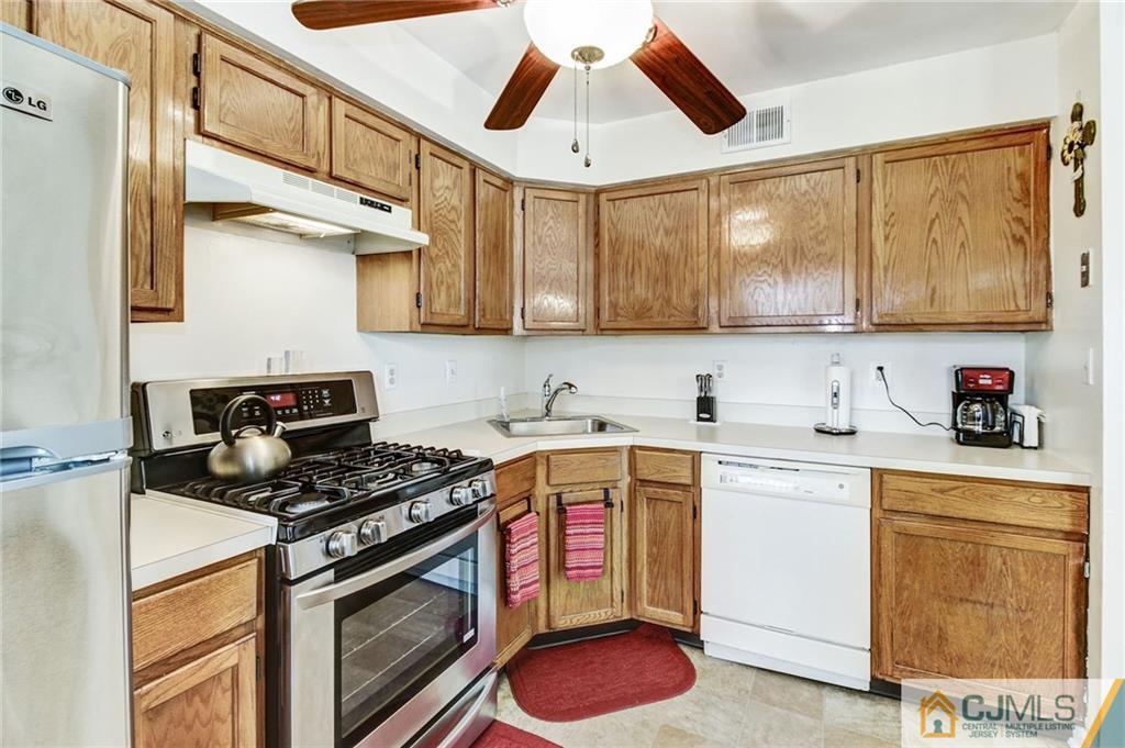 601 Porter Way West Bridgewater, NJ 08807 - Photo 5 of 15 a kitchen with stainless steel appliances granite countertop a stove a sink and a microwave
