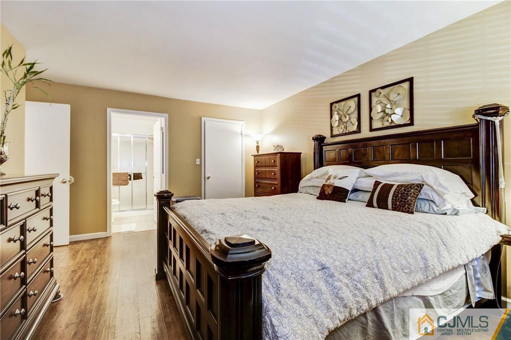 601 Porter Way West Bridgewater, NJ 08807 - Photo 9 of 15 a large bedroom with a bed and wooden floor