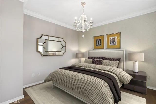 a bedroom with a bed and a chandelier