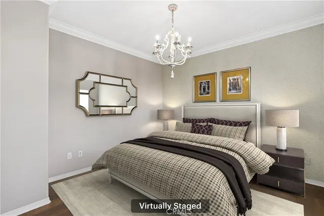 a bedroom with a bed and a chandelier
