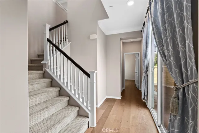 a view of a hallway with wooden floor and entryway