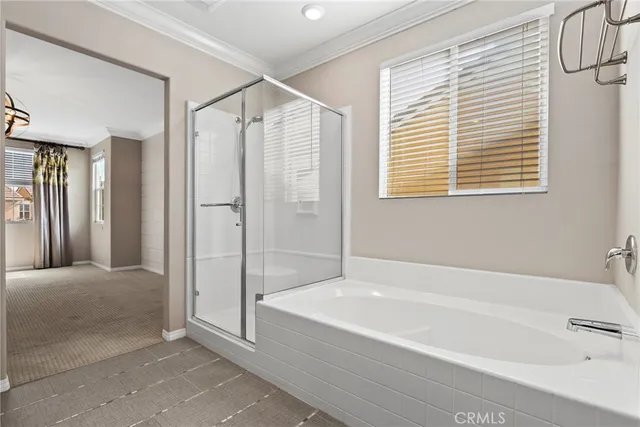 a spacious bathroom with a bathtub and a shower