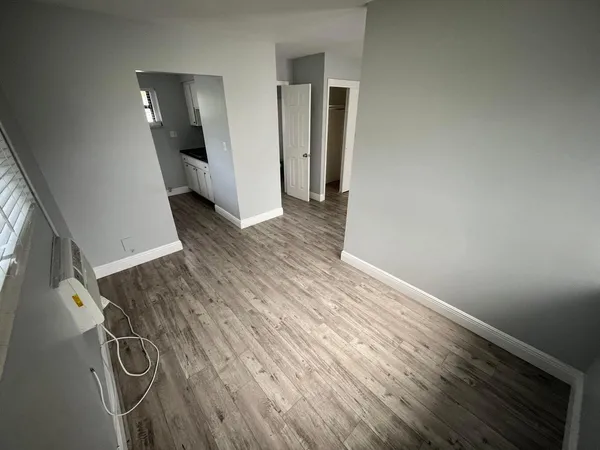 a view of a livingroom with wooden floor and staircase