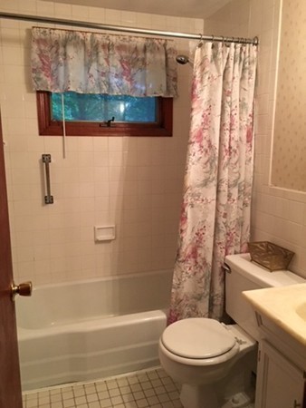6 Rindone Street Holbrook, MA 02343 - Photo 11 of 18 a white toilet sitting next to a bath tub