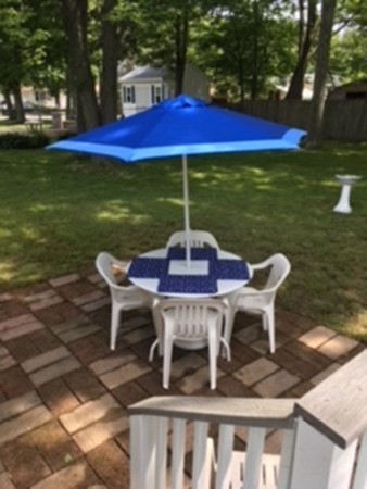 6 Rindone Street Holbrook, MA 02343 - Photo 12 of 18 a view of a patio with table and chairs under an umbrella