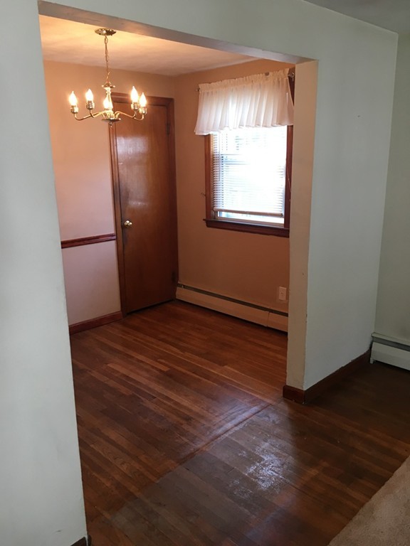 6 Rindone Street Holbrook, MA 02343 - Photo 7 of 18 a view of a room with wooden floor and chandelier
