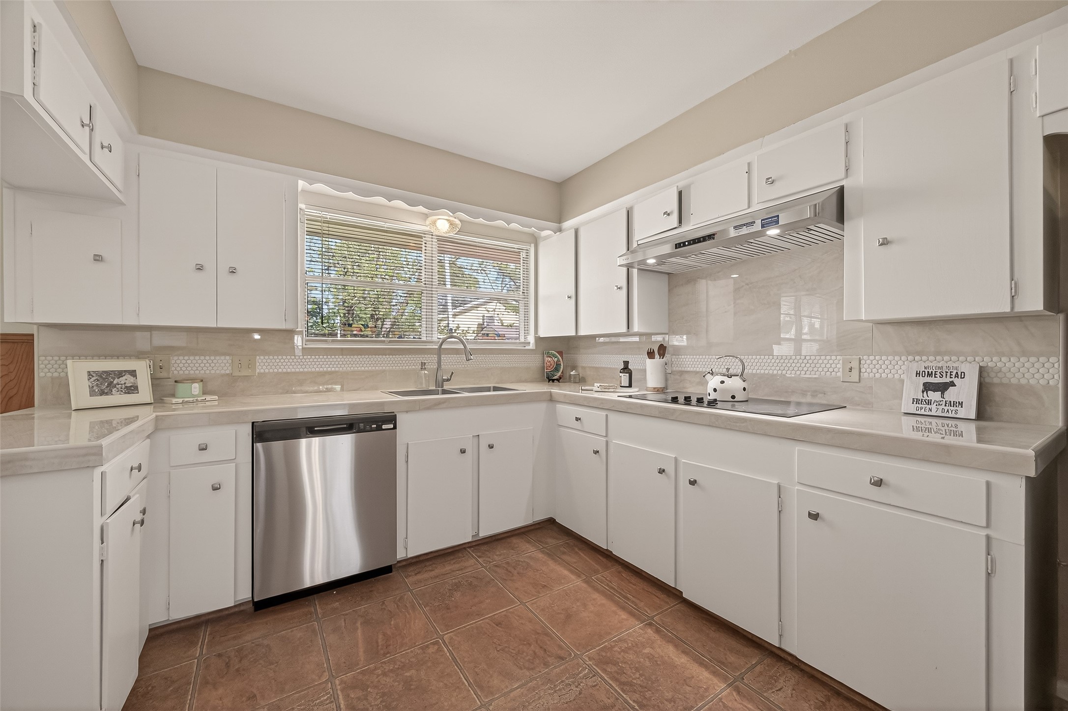 5646 Hazen Street Houston, TX 77081 - Photo 17 of 43 The kitchen features ceramic countertops and a matching backsplash, accented with beautifully patterned tile.